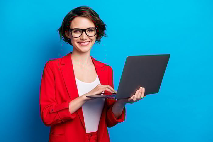 Portrait of intelligent cheerful lady skilled executive assistant holding in hand laptop working remotely isolated bright blue color background